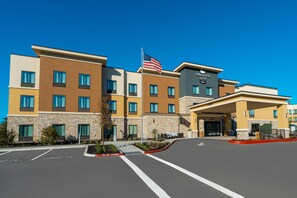 A hotel with a modern design, featuring a stone facade and a flat roof. - Homewood Suites by Hilton Livermore, CA (Livermore)