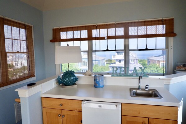A kitchen with a window, a sink, and a dish rack. - Cape Charles - Coastal Elegance, Small Town Charm (Cape Charles)