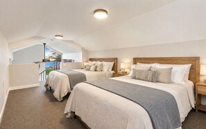 A bedroom with two beds, a skylight, and a view of the outdoors. - Beachfront Retreat with Hot Tub, Kayaks & Fire pit (Clinton)