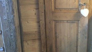 A wooden door with a handle and a light fixture attached to it. - Studio in the heart of Combloux village (Combloux)