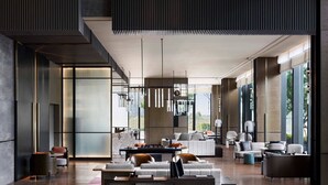 A spacious, modern living area with a large sofa set, a dining table, and a fireplace. - Wuhan Marriott Hotel Optics Valley (Wuhan)