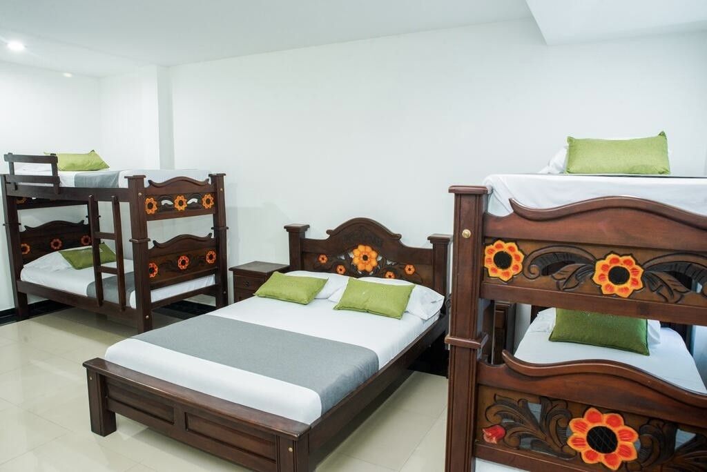 A hotel room with a single bed, a bunk bed, and a daybed.