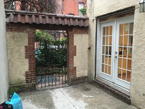 entrance to a residential building with a white door and windows.