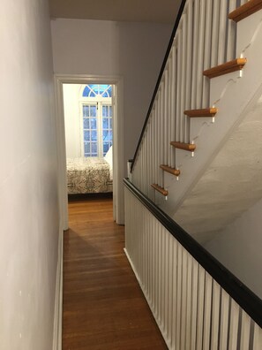 Enter a serene bedroom with a large window and a comfortable bed.