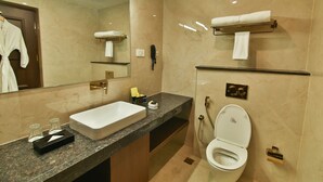 A modern bathroom with a large mirror, a sink, a toilet, and a towel rack. - Accord Chrome (Chennai)