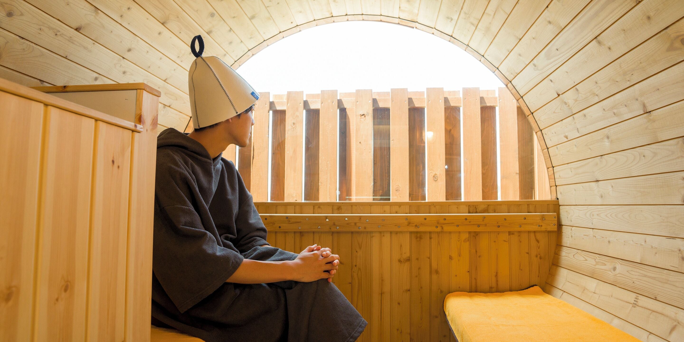 A sauna with wooden walls and a bench.