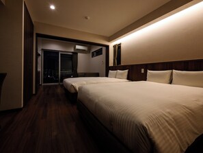A hotel room with two beds, a sliding door leading to a balcony, and a city view. - THE HOTEL CHATAN by SUNREST RESORT (Chatan)