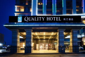 The exterior of the Quality Hotel with illuminated signage, a modern entrance, and a well-lit facade. - Quality Hotel Zhangye (Zhangye)