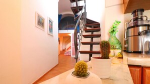 A kitchen with a marble countertop, a coffee maker, and two potted cacti. - CASA ALESSANDRA in Positano (Positano)
