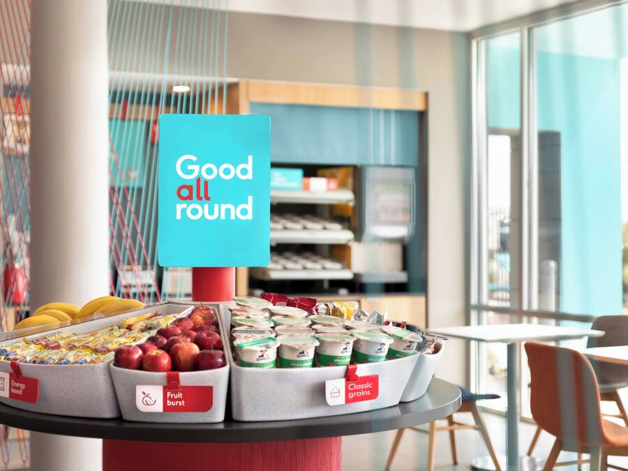 A display of food items including apples, bananas, and packaged goods with labels such as 'Energy boost' and 'Fruit burst'.