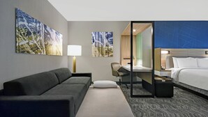 A hotel room with a sofa, a bed, a desk, and a chair. - SpringHill Suites by Marriott St. Paul Arden Hills (Arden Hills)