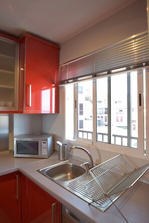 Fridge, microwave, stovetop, coffee/tea maker