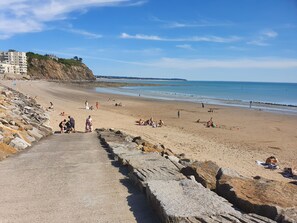 Guests can enjoy access to the beach via a stone pathway, surrounded by large boulders.