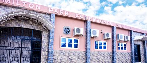 A building with a sign reading "MILTON PARK CONFERENCE HALL".