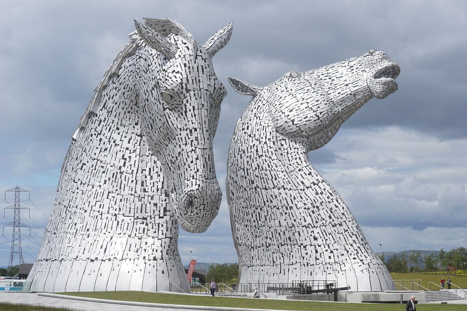 A large metallic sculpture of two horses facing each other.