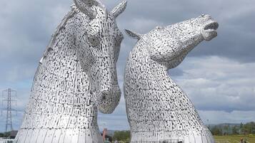 A large metallic sculpture of two horses facing each other.