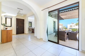 A spacious living area with a sliding glass door leading to an outdoor patio.