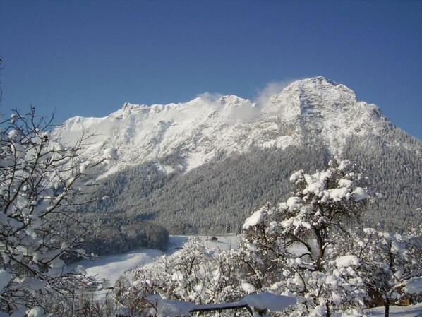 A snow-covered mountain with a clear sky.