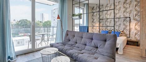 Deluxe Studio Suite | Living room | Flat-screen TV