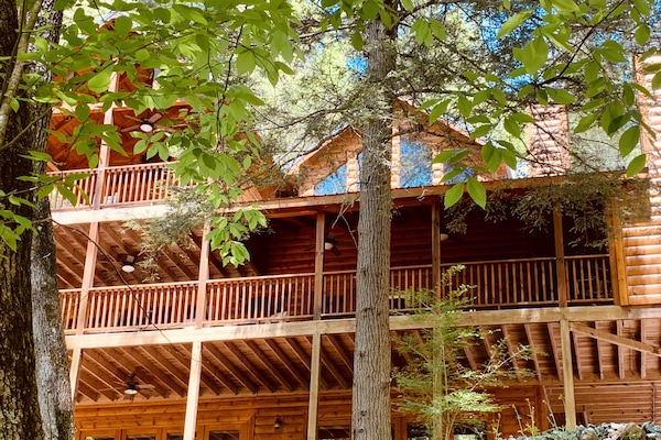 Front of cabin facing river w/ wrap around porch. Perfect for viewing wildlife.