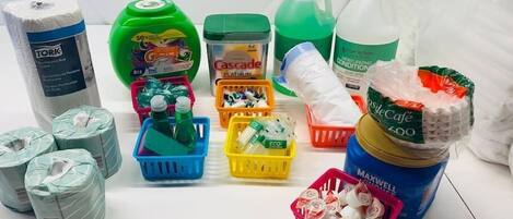 A variety of cleaning supplies including paper towels, dish soap, and personal care items.