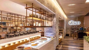 A modern hotel lobby with a central buffet area, a wine bar, and a reception desk. - Mondrian Seoul Itaewon (Seoul)