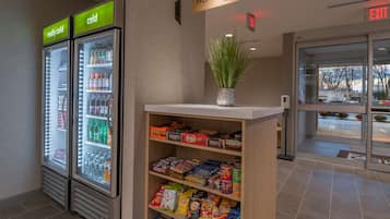 A vending area with snacks and a sign indicating 'HOME 2 MKT'.