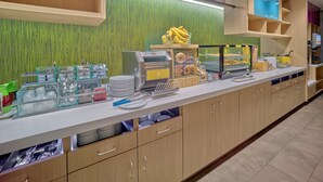 A buffet area with a variety of food items, a self-service station, and a sign that reads "Inspired Table". - Home2 Suites by Hilton Wayne, NJ (Wayne)