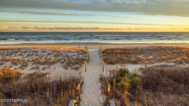 A beach path leading to the ocean with a clear sky. - "A Lil' Nauti" - 2 Bedroom Condo - Ocean Views, Emerald Isle, NC (Emerald Isle)