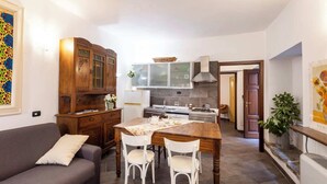 A modern kitchen with a dining table, chairs, and a built-in oven.