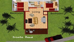 Distribución de una casa de dos pisos con sala de estar, dos dormitorios, un baño y chimenea.