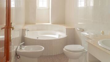 Bathtub, hair dryer, bidet, towels