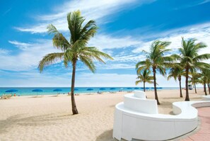 A beach with palm trees, a sandy shore, and a clear blue sky. - Fort Lauderdale apartments #4 - Centrally Located! (Fort Lauderdale)