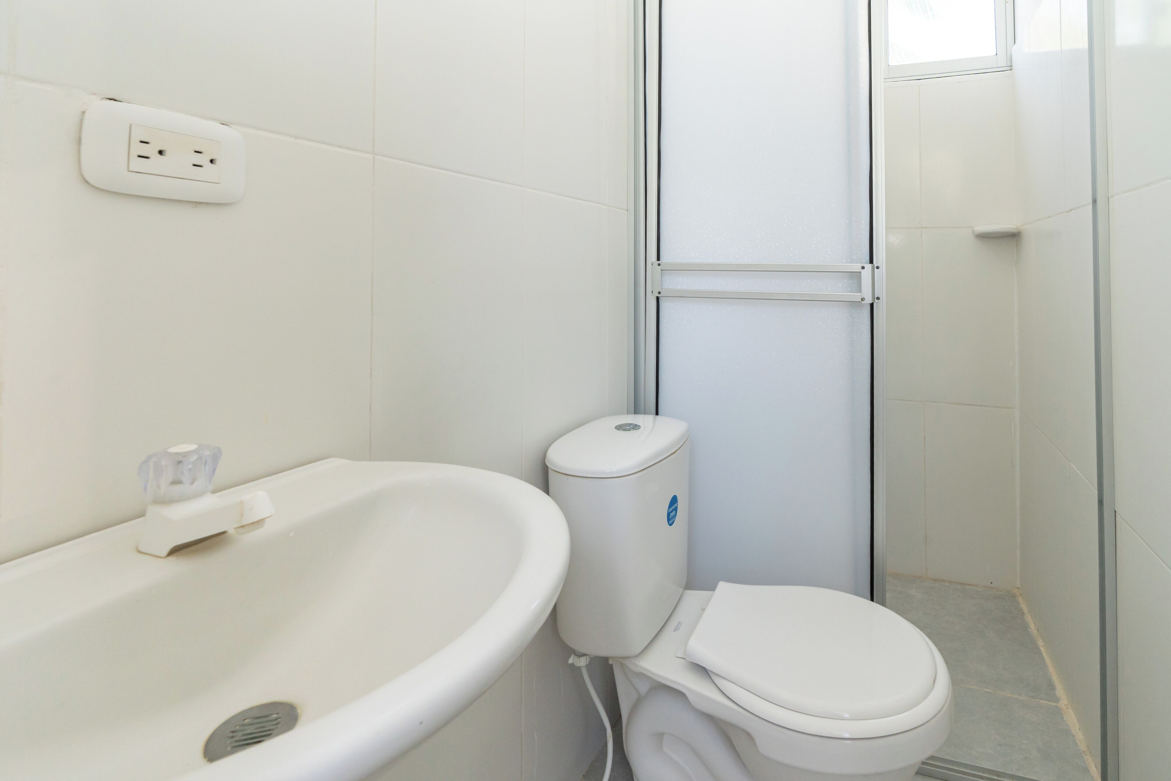 A bathroom with a sink, toilet, and shower.