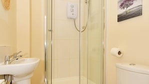 A bathroom with a glass-enclosed shower, a white sink, and a toilet. - Townhouse @ 178 Ruskin Road Crewe (Crewe)