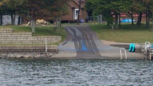 A lakeside park with a paved path, a small building, and a dock with a ladder. - Lovely Mount Storm Waterfront Lake House - pet friendly, child friendly retreat (Mt Storm)