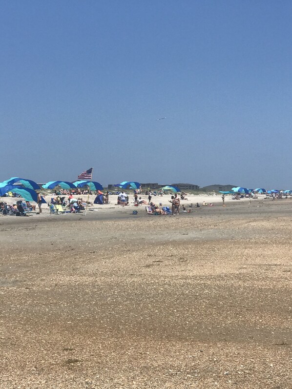 A beach with tents and people.