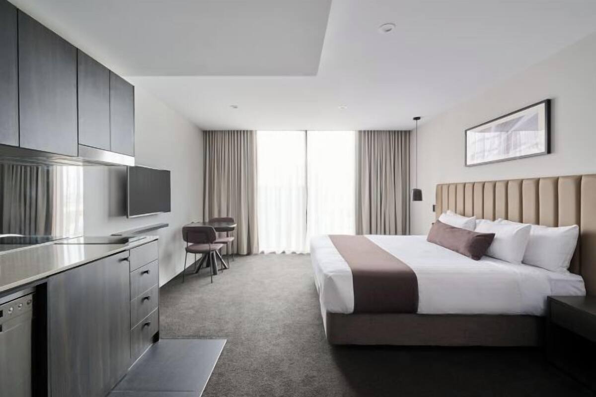 Premium bedding, desk, laptop workspace, iron/ironing board