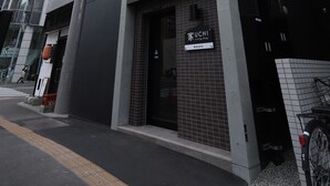 A modern building with a sign that reads "SUSHI". - UCHI Living Stay AOZORA (Sapporo)