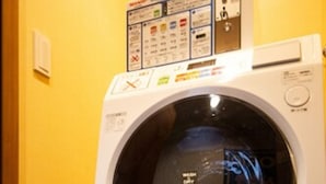 A front-loading washing machine with a control panel and safety instructions. - The L.A. Mart Hotel Kyoto (Kyoto)