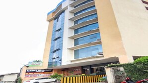 A hotel with a modern facade, multiple floors, and a reception area on the ground floor. - Jy Crown Palace (Cebu City)