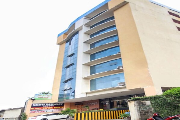 A hotel with a modern facade, multiple floors, and a reception area on the ground floor. - Jy Crown Palace (Cebu City)