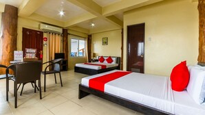 A hotel room with two beds, a desk, and chairs. - Jy Crown Palace (Cebu City)