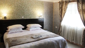 Desk, iron/ironing board, bed sheets