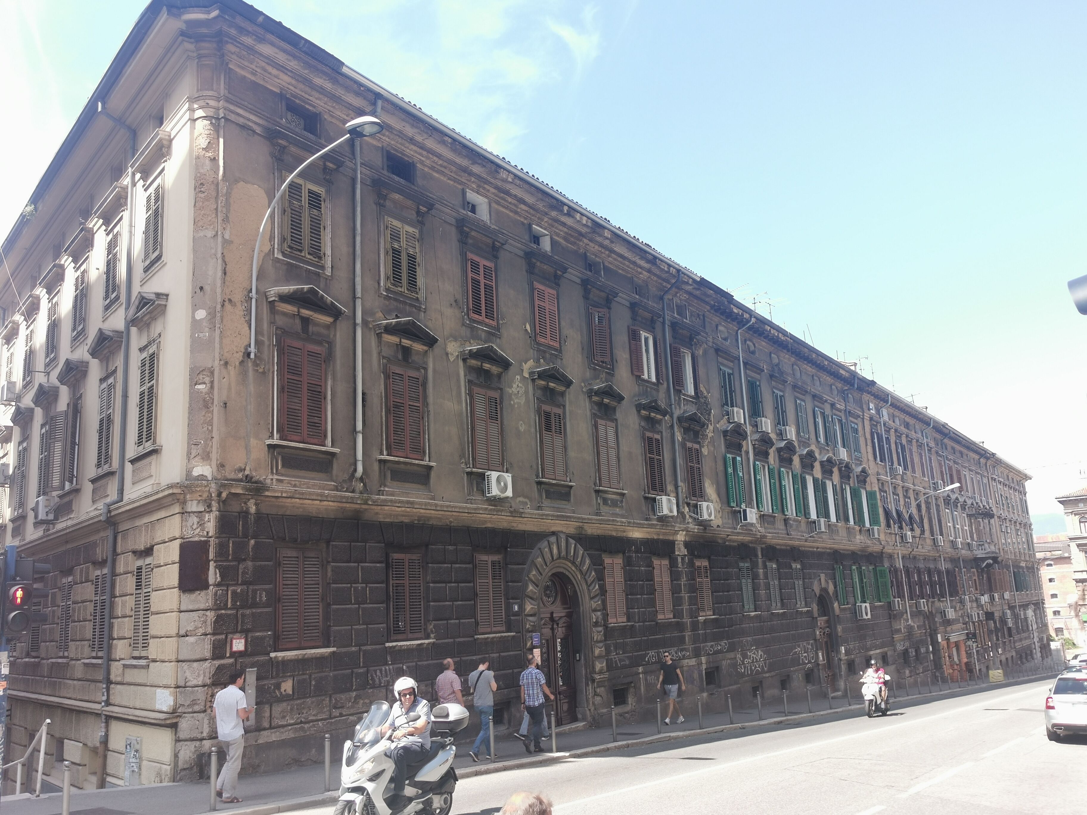 A historic building with multiple windows and a large entrance.