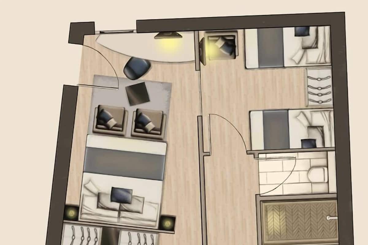 Layout de um quarto de hotel com cama, área de estar, cozinha compacta e banheiro.