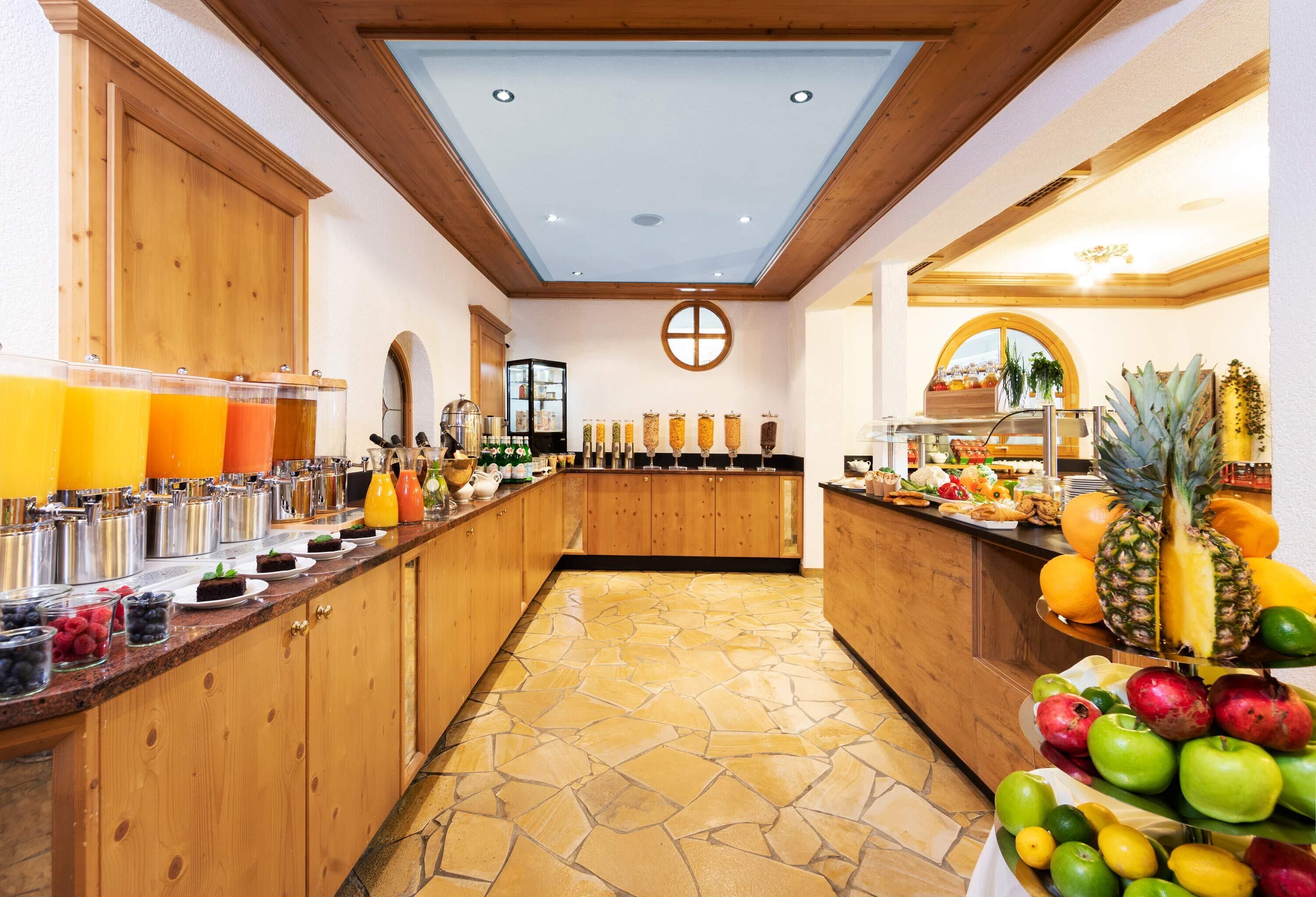 A breakfast bar with various food items and beverages.