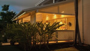 A house with a porch, a covered outdoor area, and a visible window.