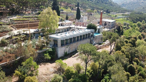 A modern building with a rooftop pool, surrounded by lush greenery and vineyards. - The Silk Valley Resort (Aarbaniye)