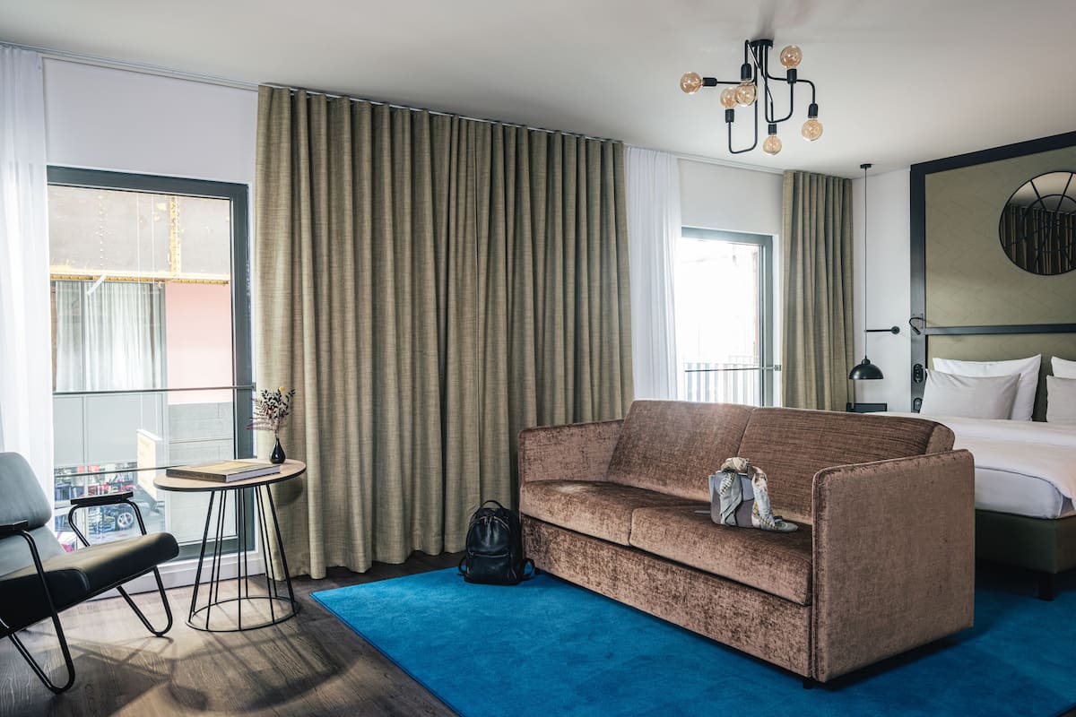 premium double room | living area | 55-inch flat-screen tv with cable channels, tv, tablet